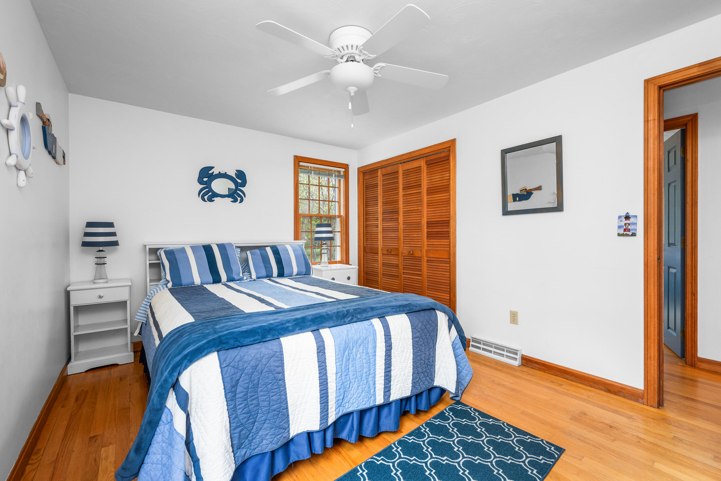 5 Blueberry Island Road Orleans, MA 02653 - Photo 22 of 39 a bedroom with a bed and a chandelier