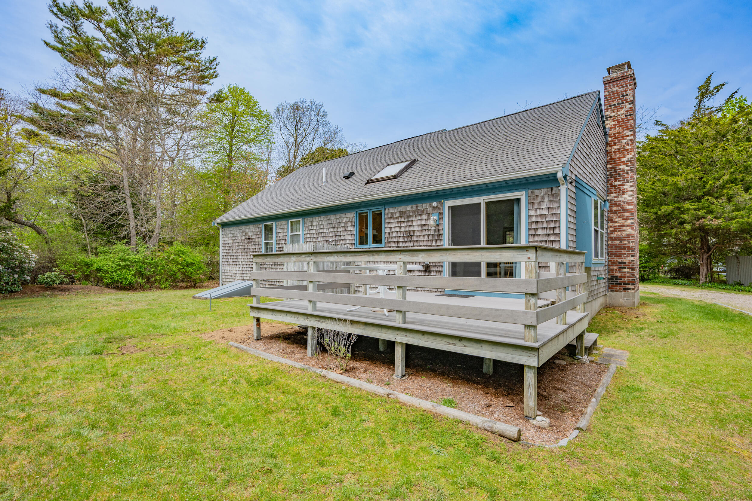 5 Blueberry Island Road Orleans, MA 02653 - Photo 24 of 39 a view of a house with a backyard and a patio