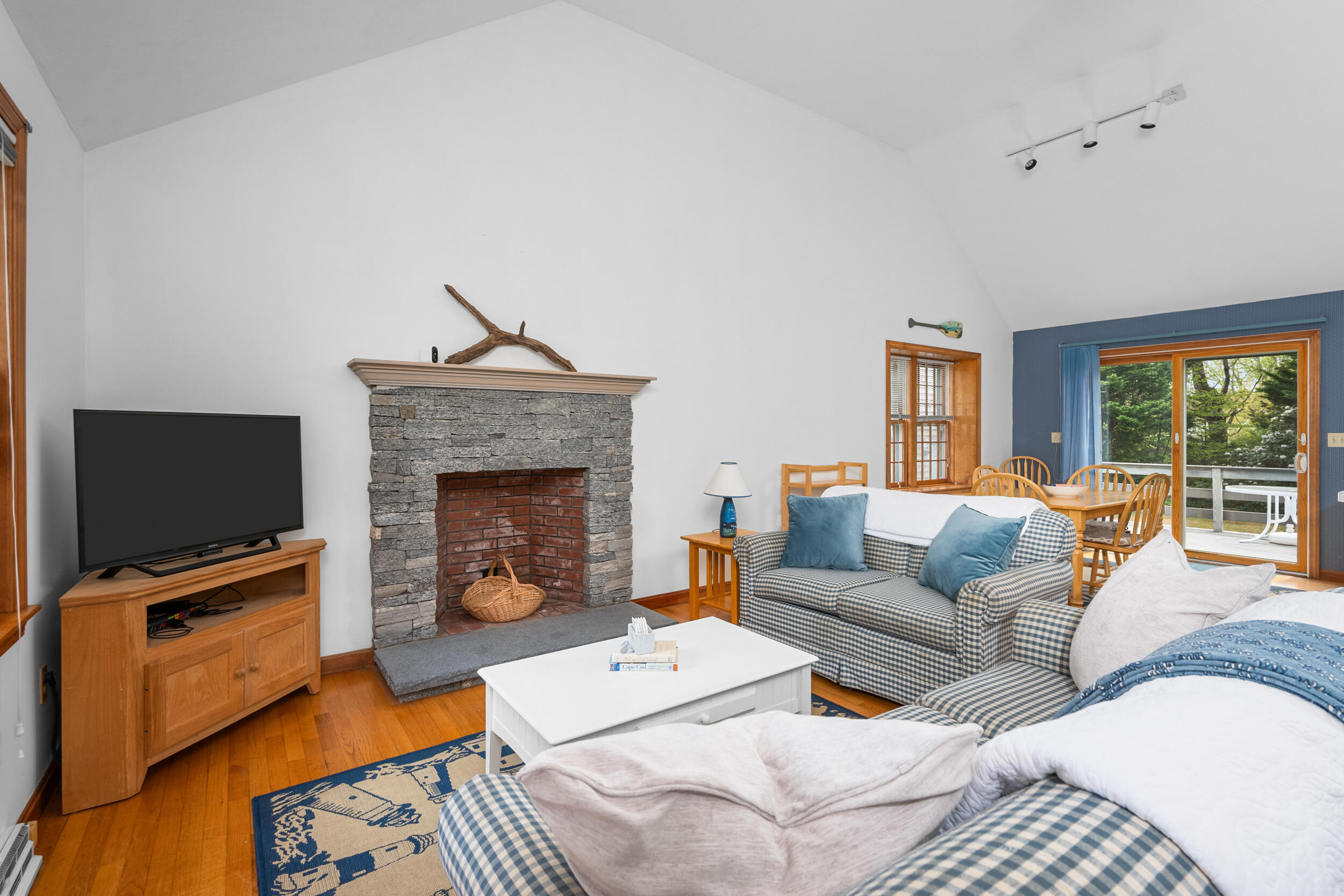 5 Blueberry Island Road Orleans, MA 02653 - Photo 6 of 39 a living room with furniture a flat screen tv and a fireplace