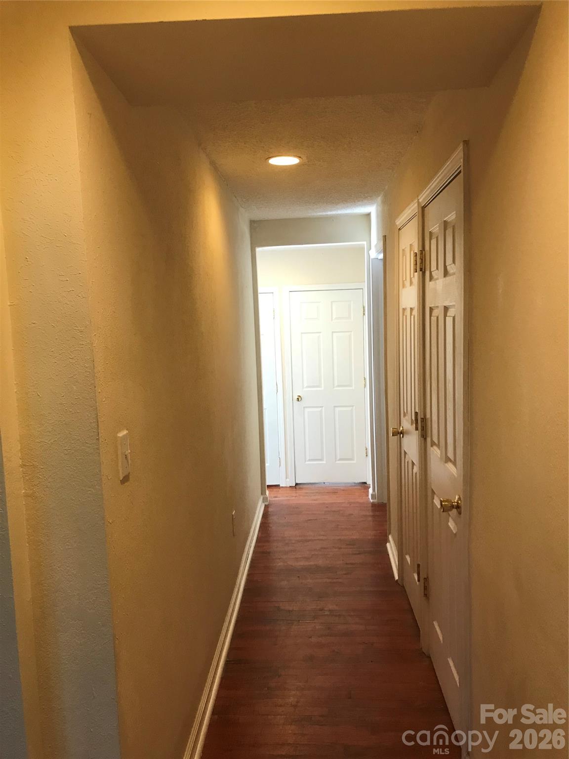 545 Avery Creek Road Arden, NC 28704 - Photo 13 of 35 a view of a hallway with wooden floor