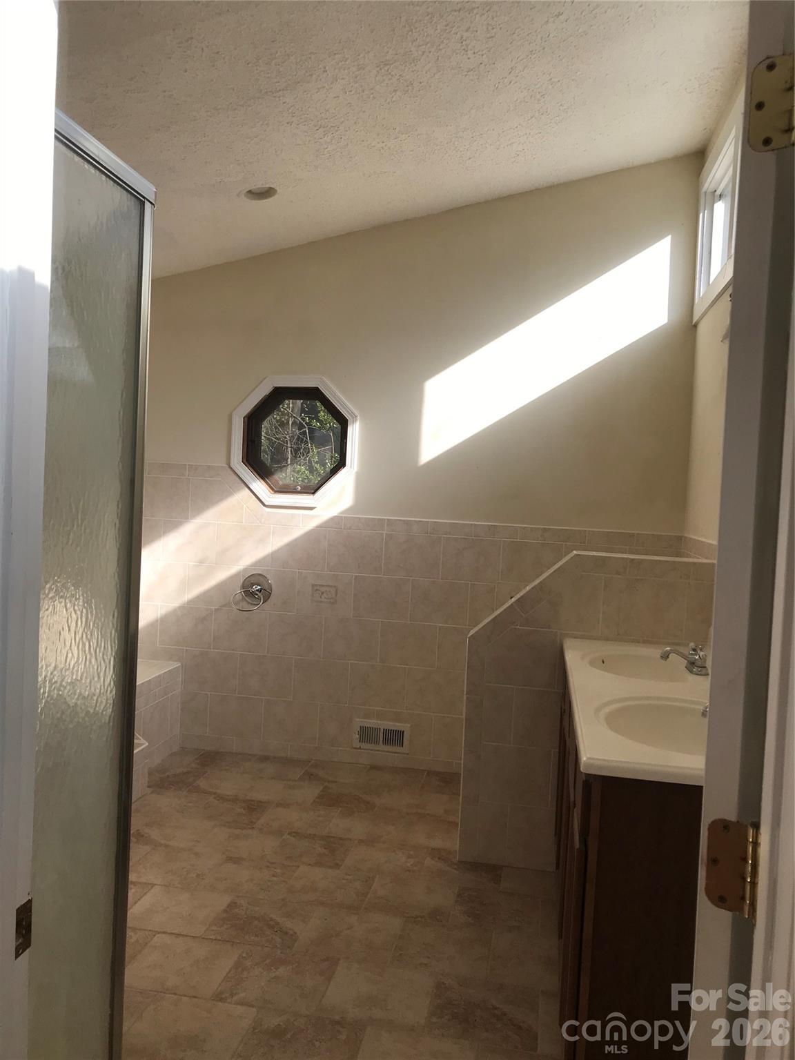 545 Avery Creek Road Arden, NC 28704 - Photo 25 of 35 a bathroom with a shower and a sink
