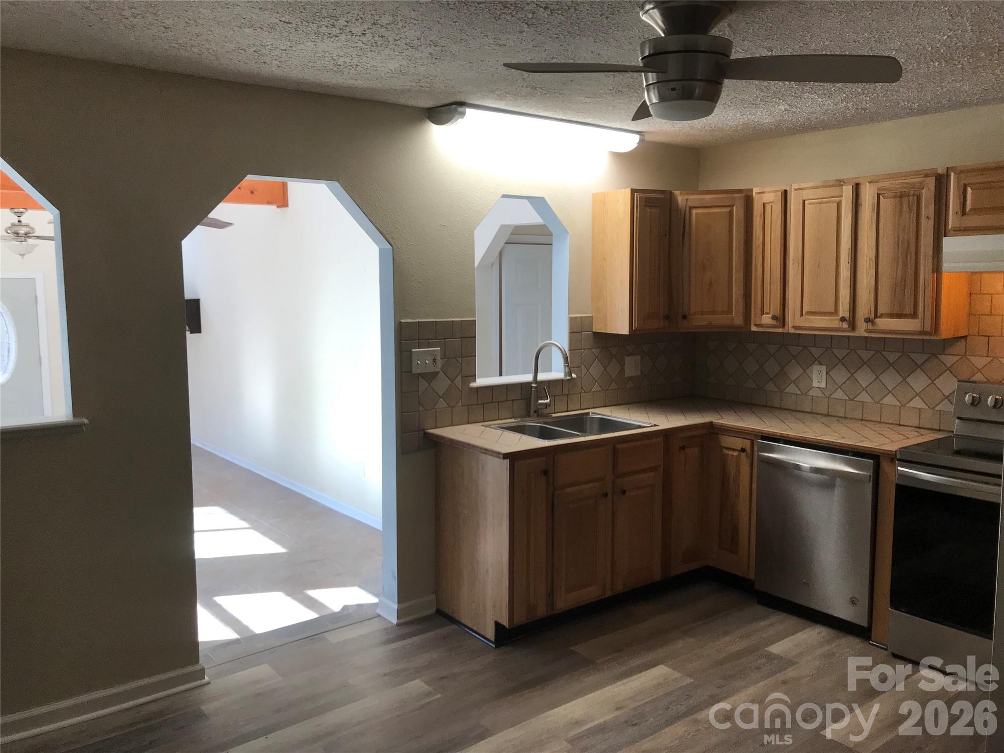 545 Avery Creek Road Arden, NC 28704 - Photo 7 of 35 a kitchen with stainless steel appliances granite countertop a sink and a stove