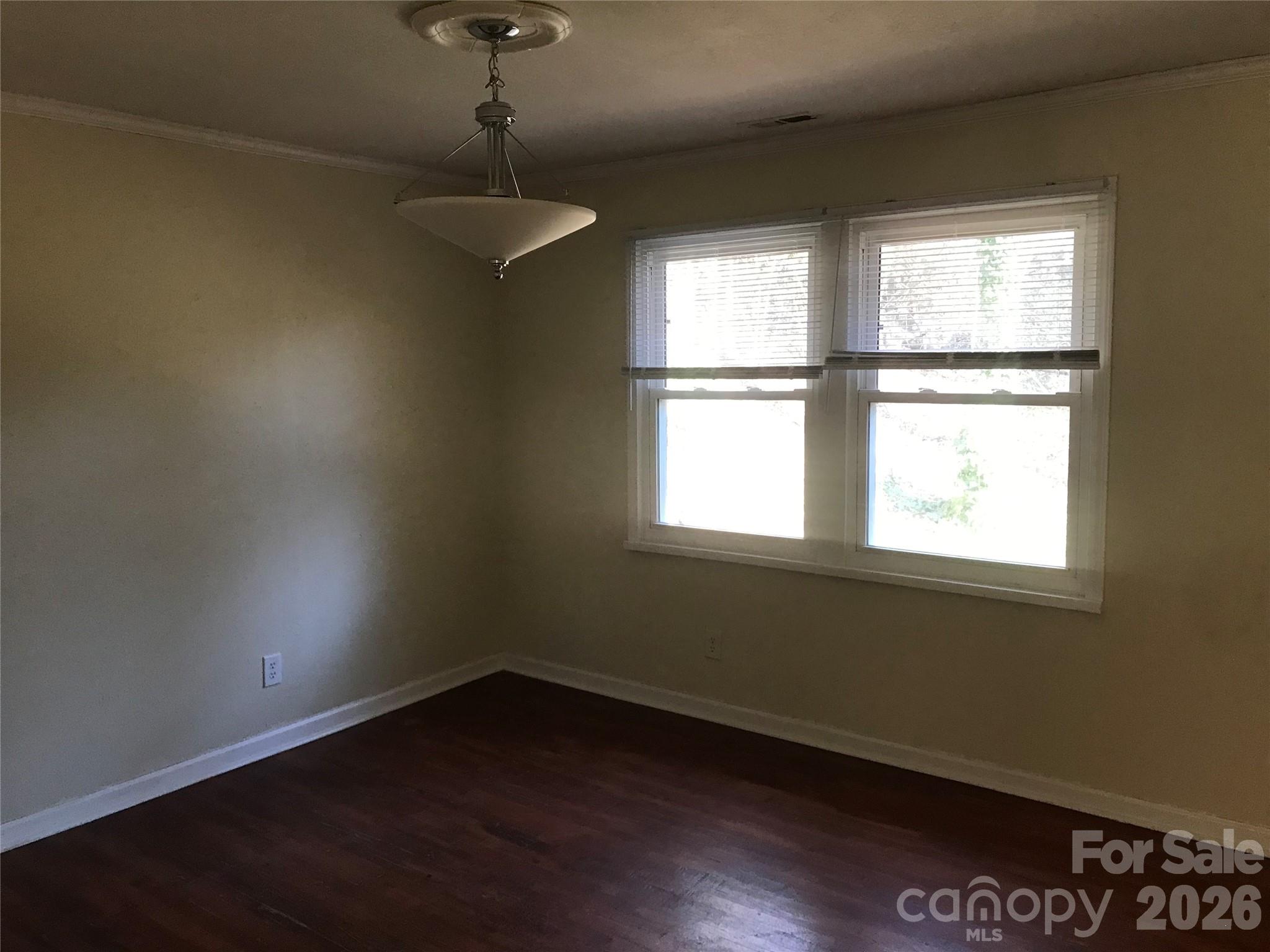 545 Avery Creek Road Arden, NC 28704 - Photo 8 of 35 a view of an empty room with wooden floor and a window