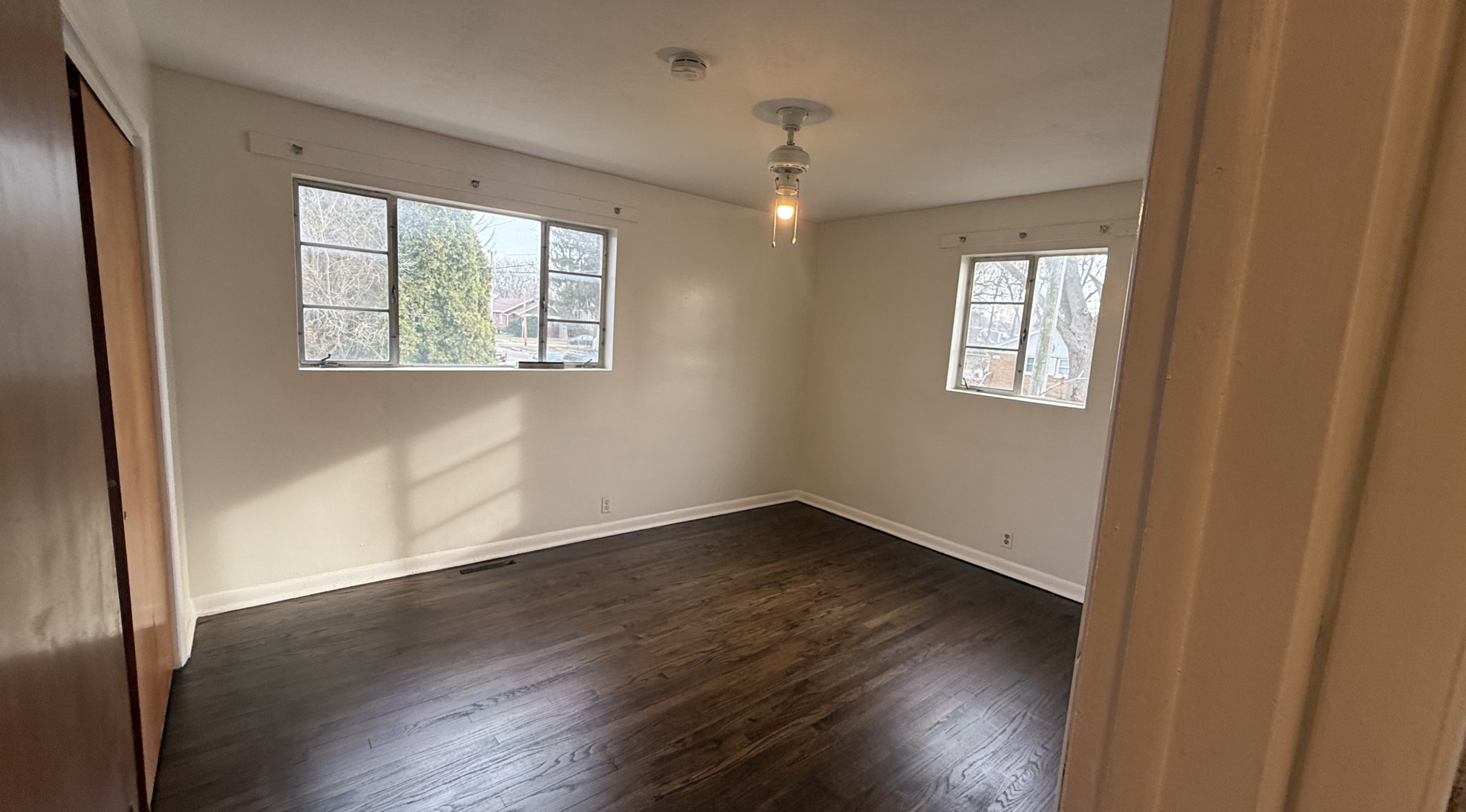 1014 Edwards Street, Unit 1 Waukegan, IL 60085 - Photo 7 of 10 a view of an empty room with wooden floor and a window