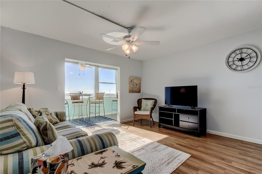 4775 Cove Circle, Unit 1105 St. Petersburg, FL 33708 - Photo 14 of 40 a bedroom with furniture and a flat screen tv