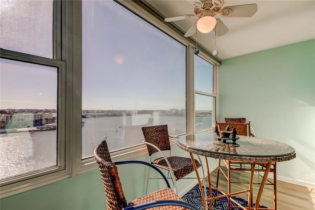 4775 Cove Circle, Unit 1105 St. Petersburg, FL 33708 - Photo 16 of 40 a dining room with furniture and a window