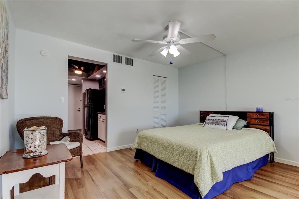 4775 Cove Circle, Unit 1105 St. Petersburg, FL 33708 - Photo 18 of 40 a bedroom with a bed and dresser