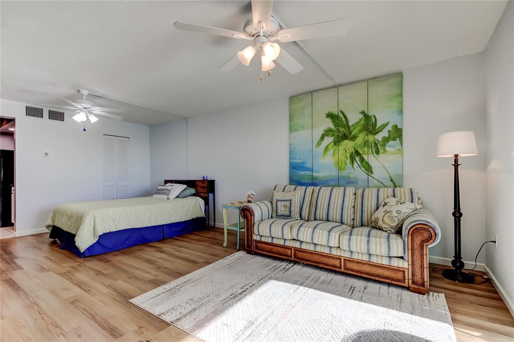 4775 Cove Circle, Unit 1105 St. Petersburg, FL 33708 - Photo 19 of 40 a bedroom with a bed window and couch
