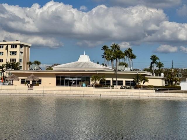 4775 Cove Circle, Unit 1105 St. Petersburg, FL 33708 - Photo 34 of 40 a front view of a building with river and trees in the background