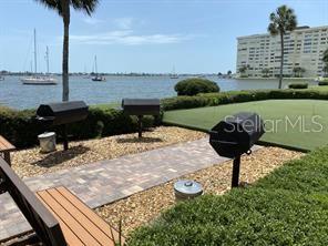 4775 Cove Circle, Unit 1105 St. Petersburg, FL 33708 - Photo 39 of 40 a view of a lake with a terrace