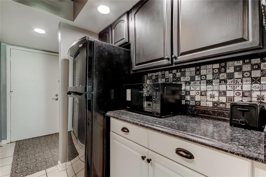 4775 Cove Circle, Unit 1105 St. Petersburg, FL 33708 - Photo 5 of 40 a kitchen with a refrigerator and cabinets