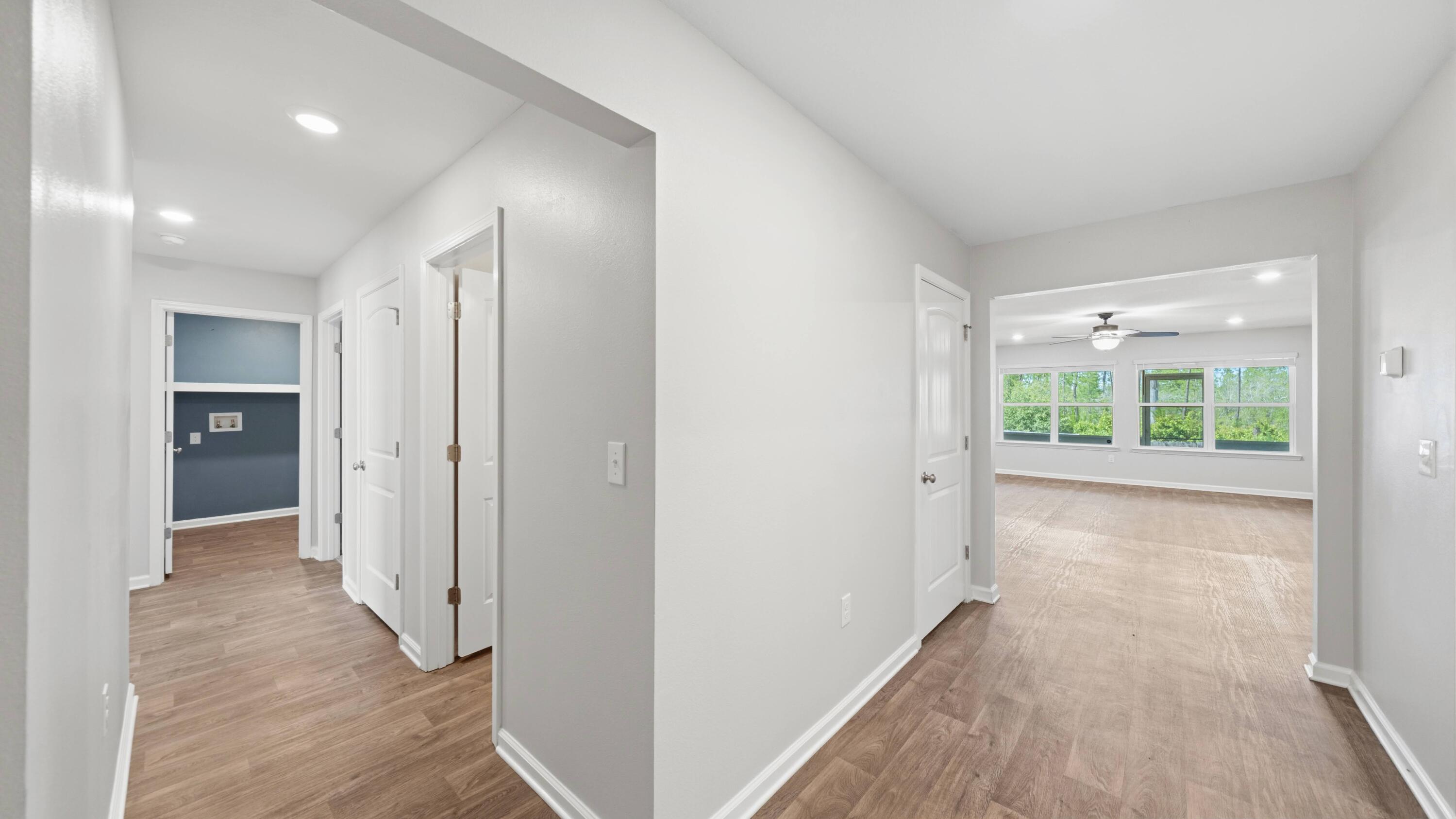 3927 Alva Thomas Road Panama City, FL 32404 - Photo 17 of 46 a view of a big room with wooden floor and windows