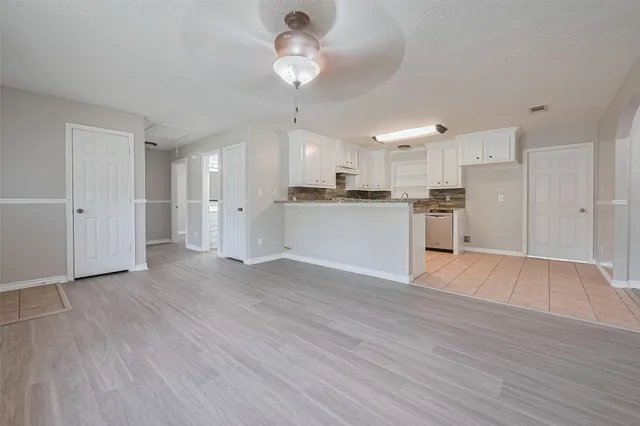 a view of a kitchen with a refrigerator and a stove top oven