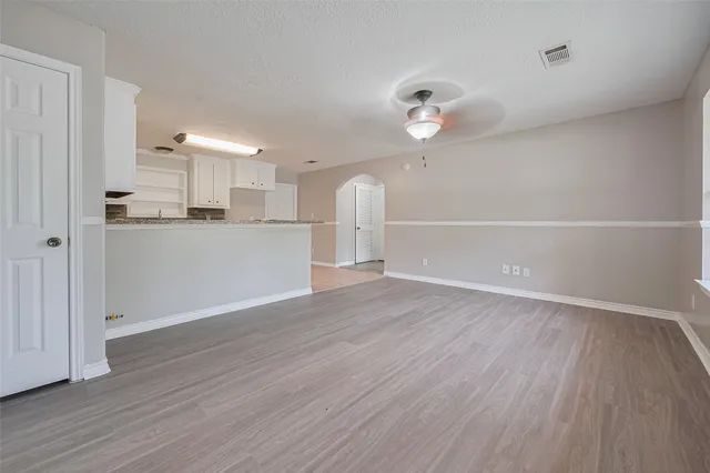 a view of a kitchen with wooden floor and window
