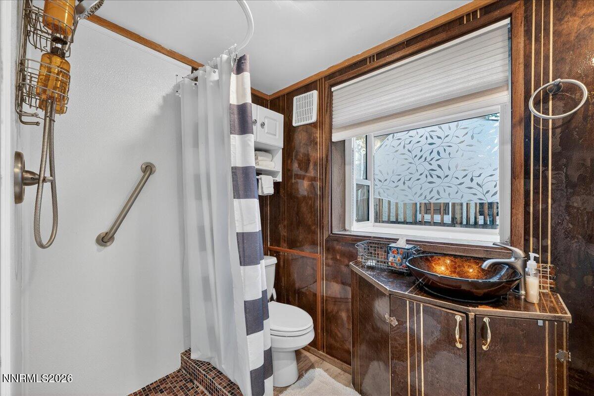 611 Nixon Avenue Reno, NV 89509 - Photo 22 of 43 a bathroom with a sink a toilet and a shower