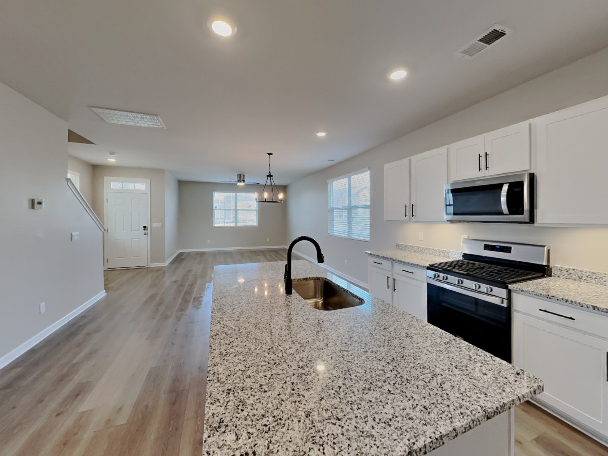 1406 Ashfield Place Lebanon, TN 37087 - Photo 6 of 17 a kitchen with stainless steel appliances granite countertop a sink stove and refrigerator