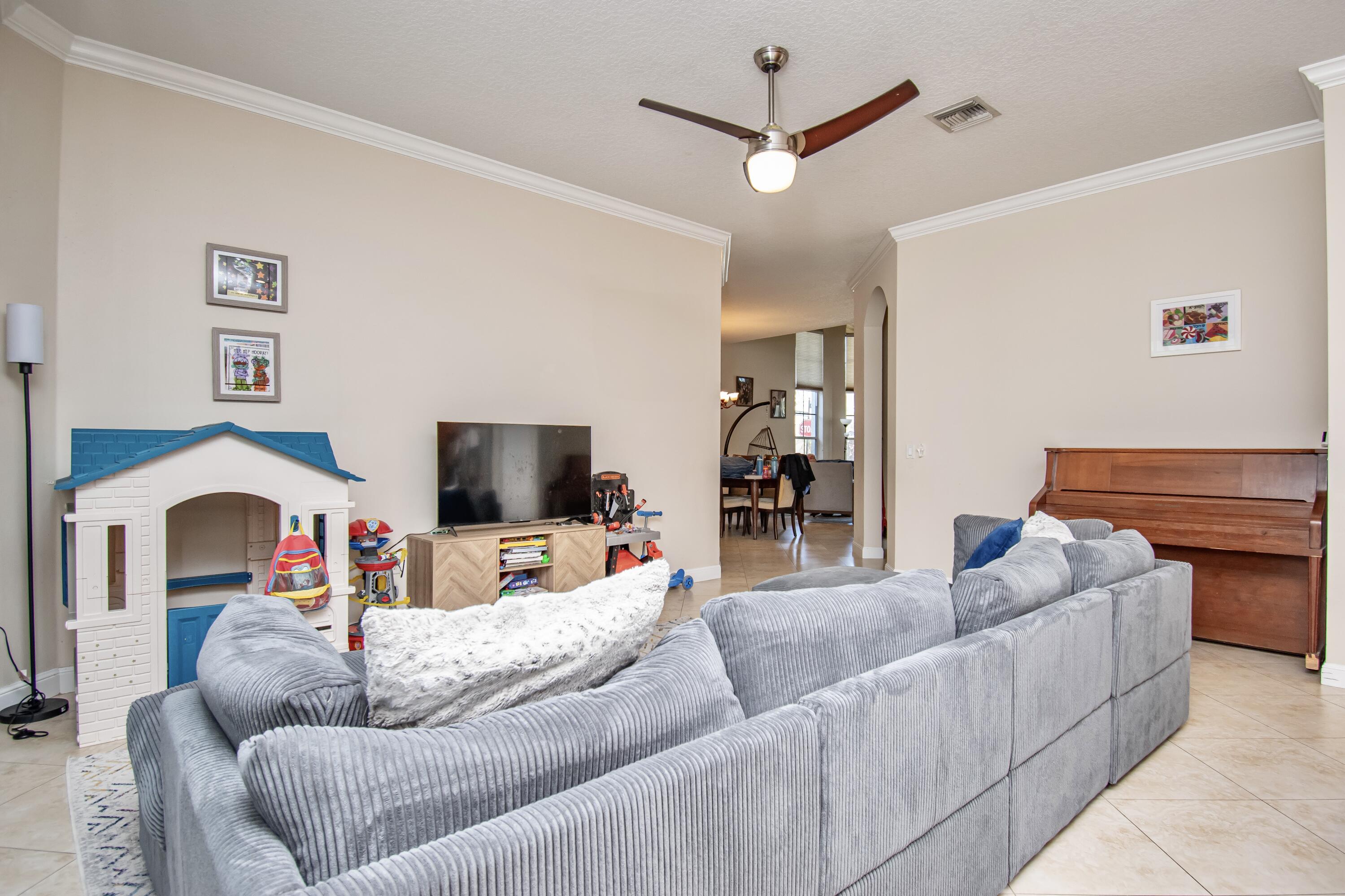 9851 Palma Vista Way Boca Raton, FL 33428 - Photo 13 of 33 a living room with furniture and a flat screen tv