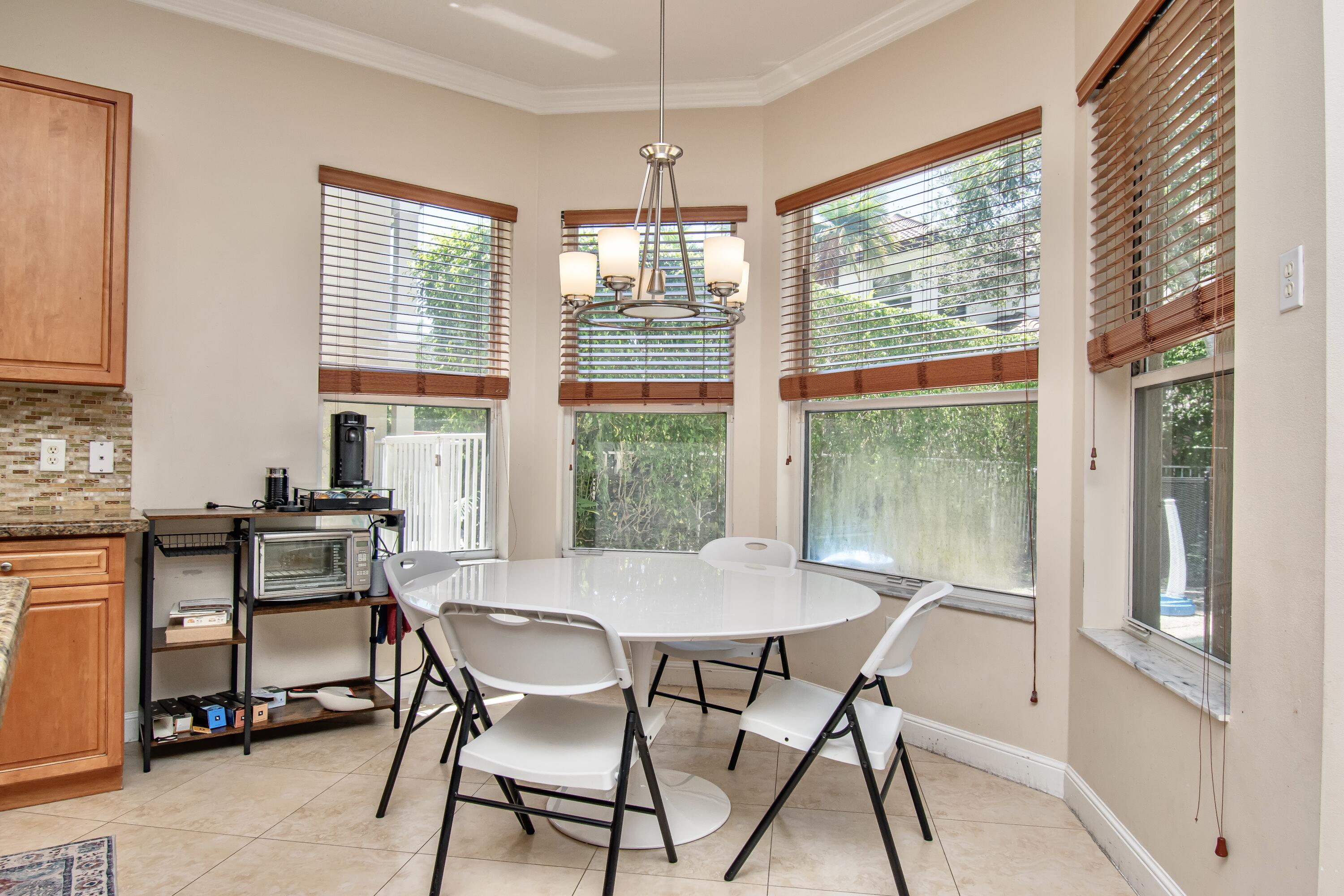 9851 Palma Vista Way Boca Raton, FL 33428 - Photo 19 of 33 a view of a dining room with furniture window and outside view