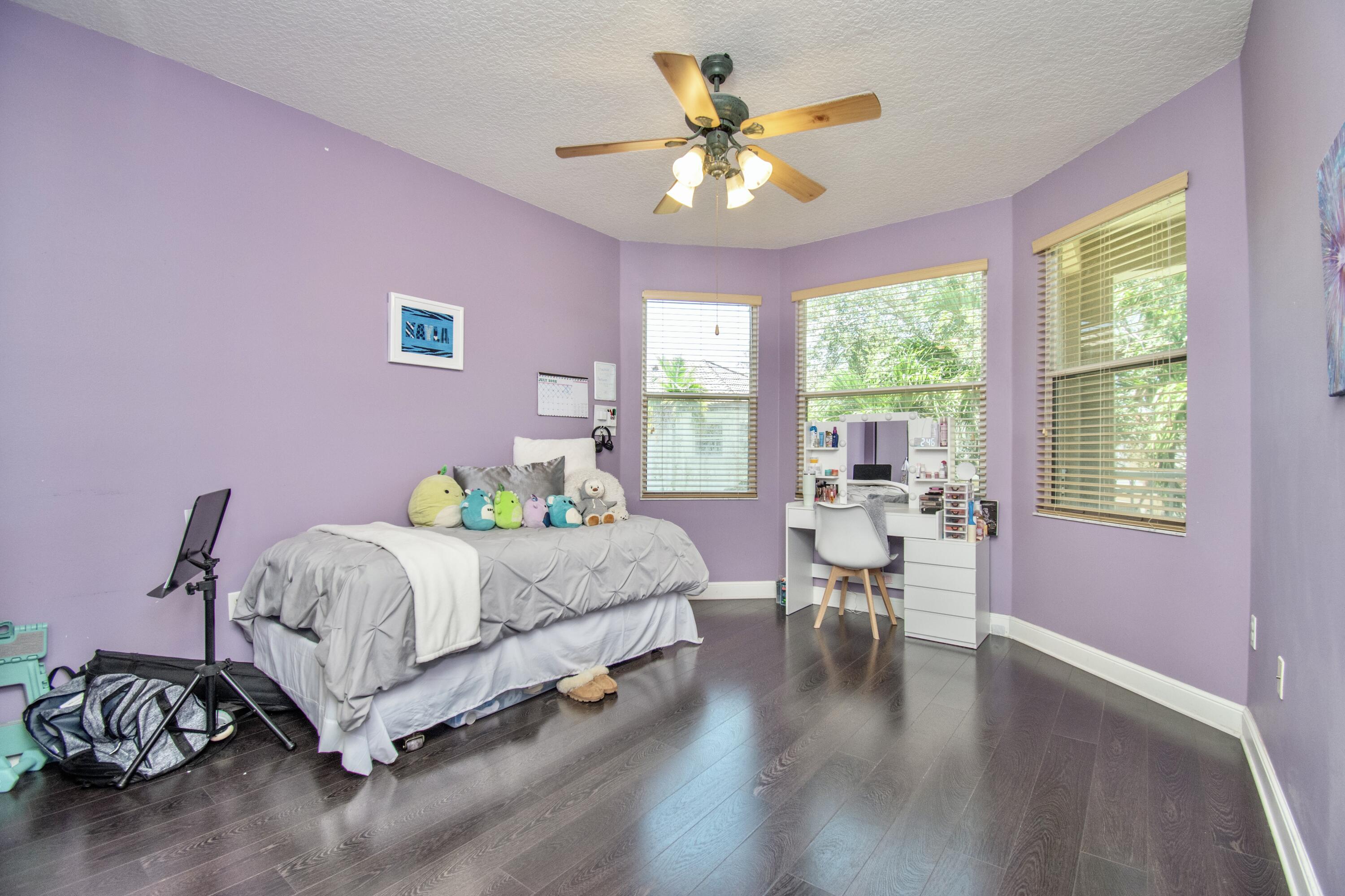 9851 Palma Vista Way Boca Raton, FL 33428 - Photo 26 of 33 a bedroom with a bed and a chandelier