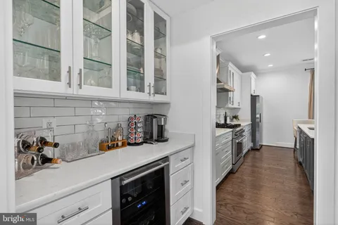 a kitchen with cabinets and a refrigerator