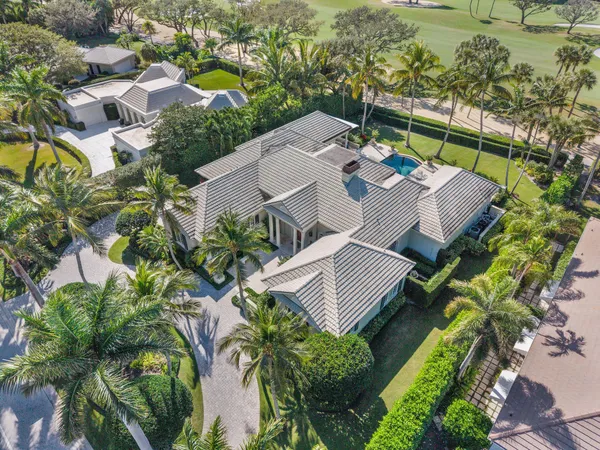 an aerial view of a house with swimming pool and outdoor space