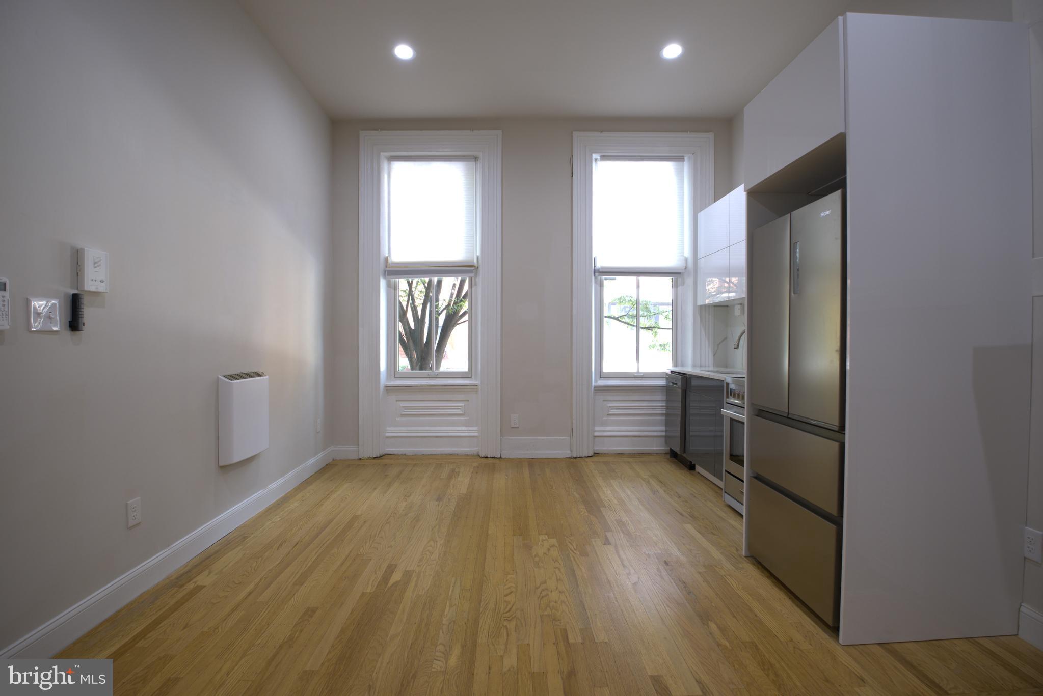 333 South 21st Street, Unit 1F Philadelphia, PA 19103 - Photo 3 of 15 wooden floor in an empty room with a window