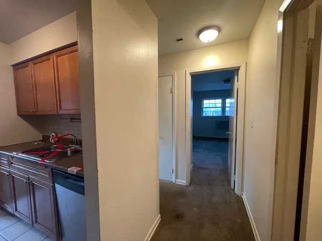 a kitchen with a refrigerator and cabinets