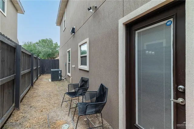 a backyard of a house with table and chairs