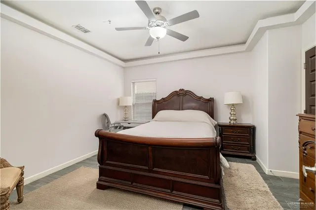 a bedroom with a bed and a ceiling fan