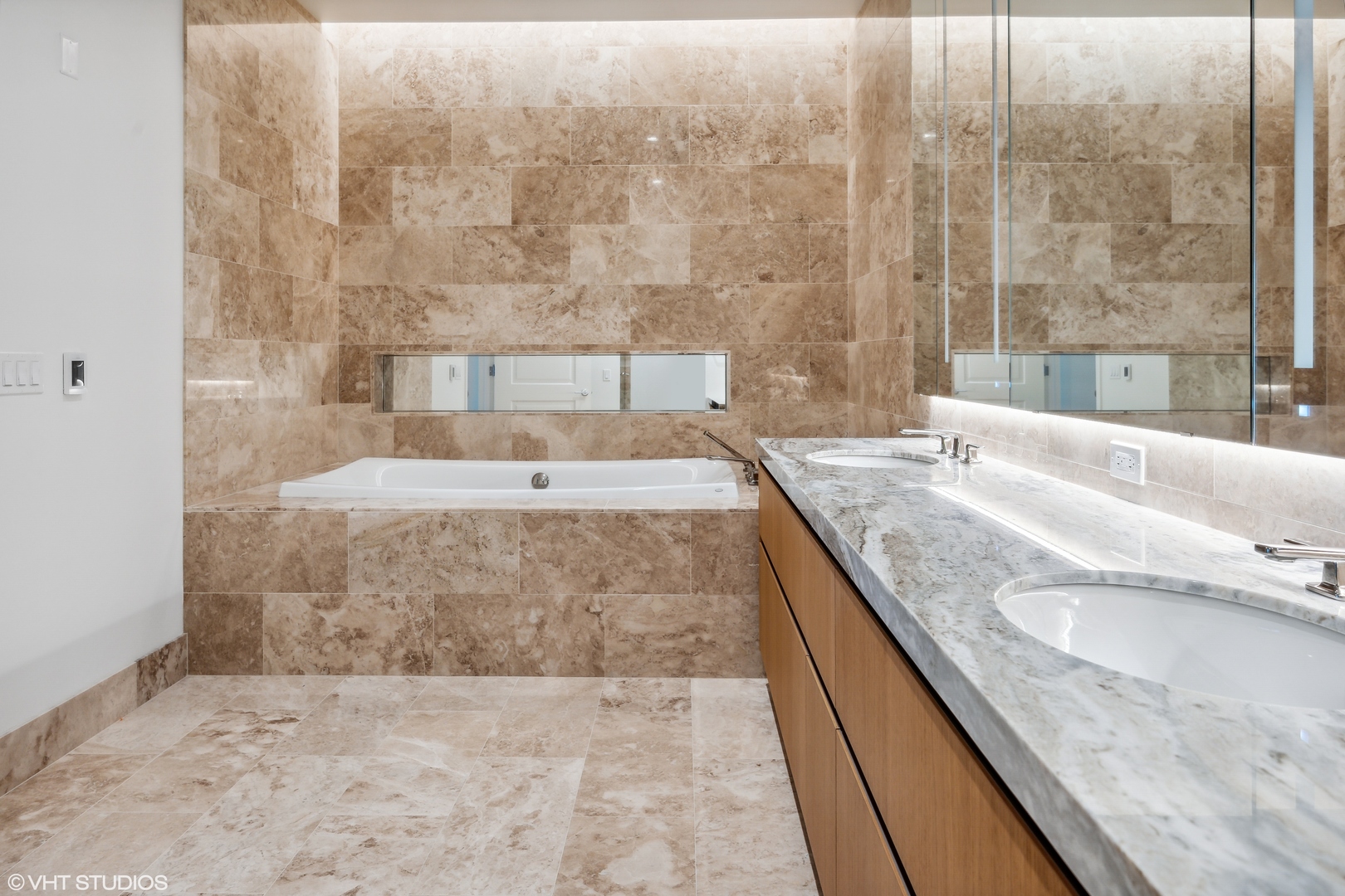 363 East Wacker Drive, Unit 2709 Chicago, IL 60601 - Photo 11 of 25 a bathroom with a granite countertop bathtub sink vanity and shower