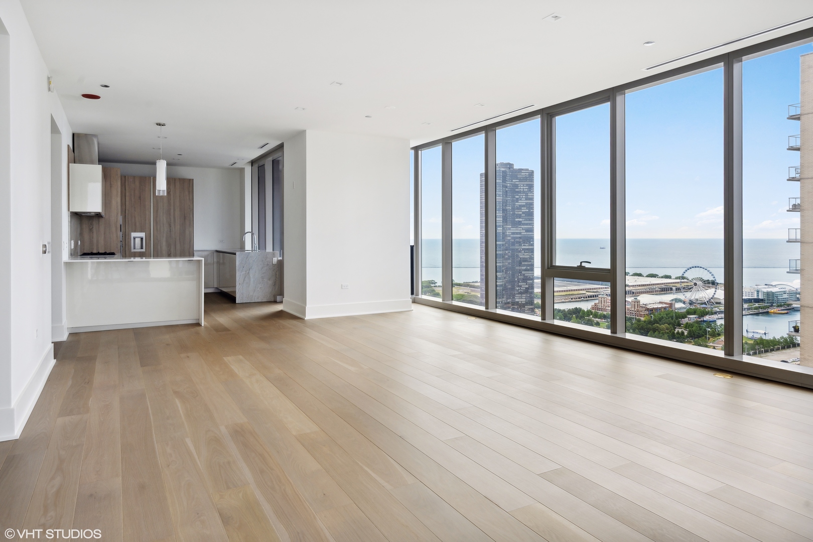 363 East Wacker Drive, Unit 2709 Chicago, IL 60601 - Photo 4 of 25 a view of empty room with wooden floor and floor to ceiling window