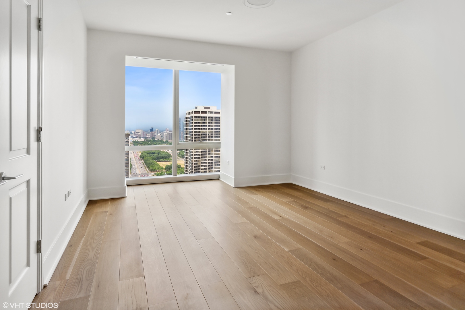 363 East Wacker Drive, Unit 2709 Chicago, IL 60601 - Photo 8 of 25 an empty room with wooden floor and windows