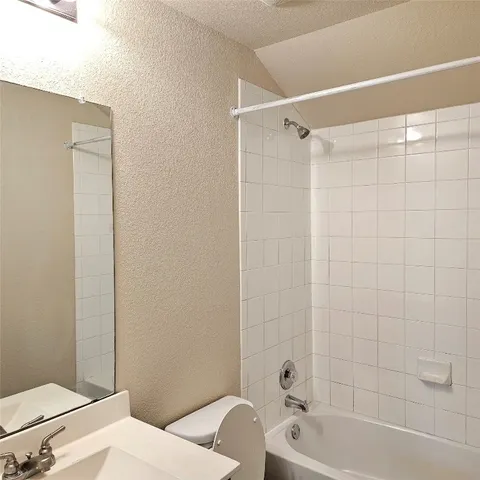a bathroom with a bathtub and shower