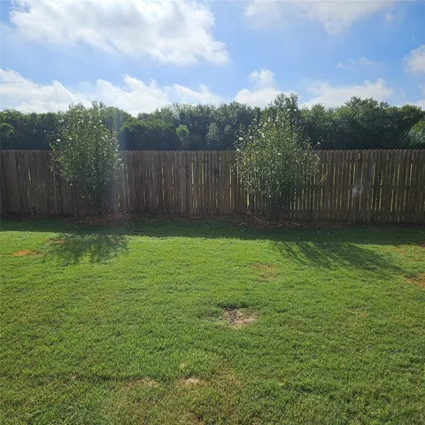 a view of a yard with a house in the background