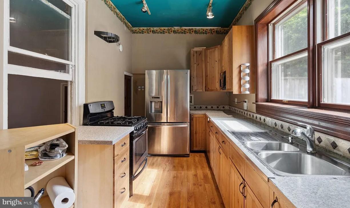 803 North 5th Street Philadelphia, PA 19123 - Photo 7 of 19 a kitchen with stainless steel appliances granite countertop a sink stove and refrigerator