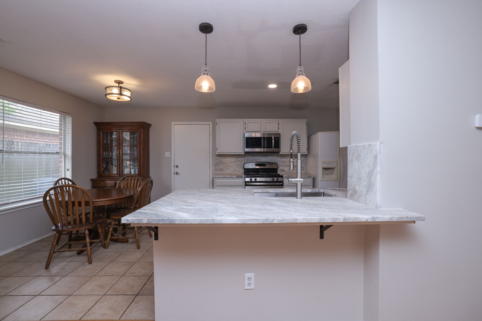 3803 Oaklace Drive Spring, TX 77389 - Photo 14 of 36 a kitchen with sink cabinets and window