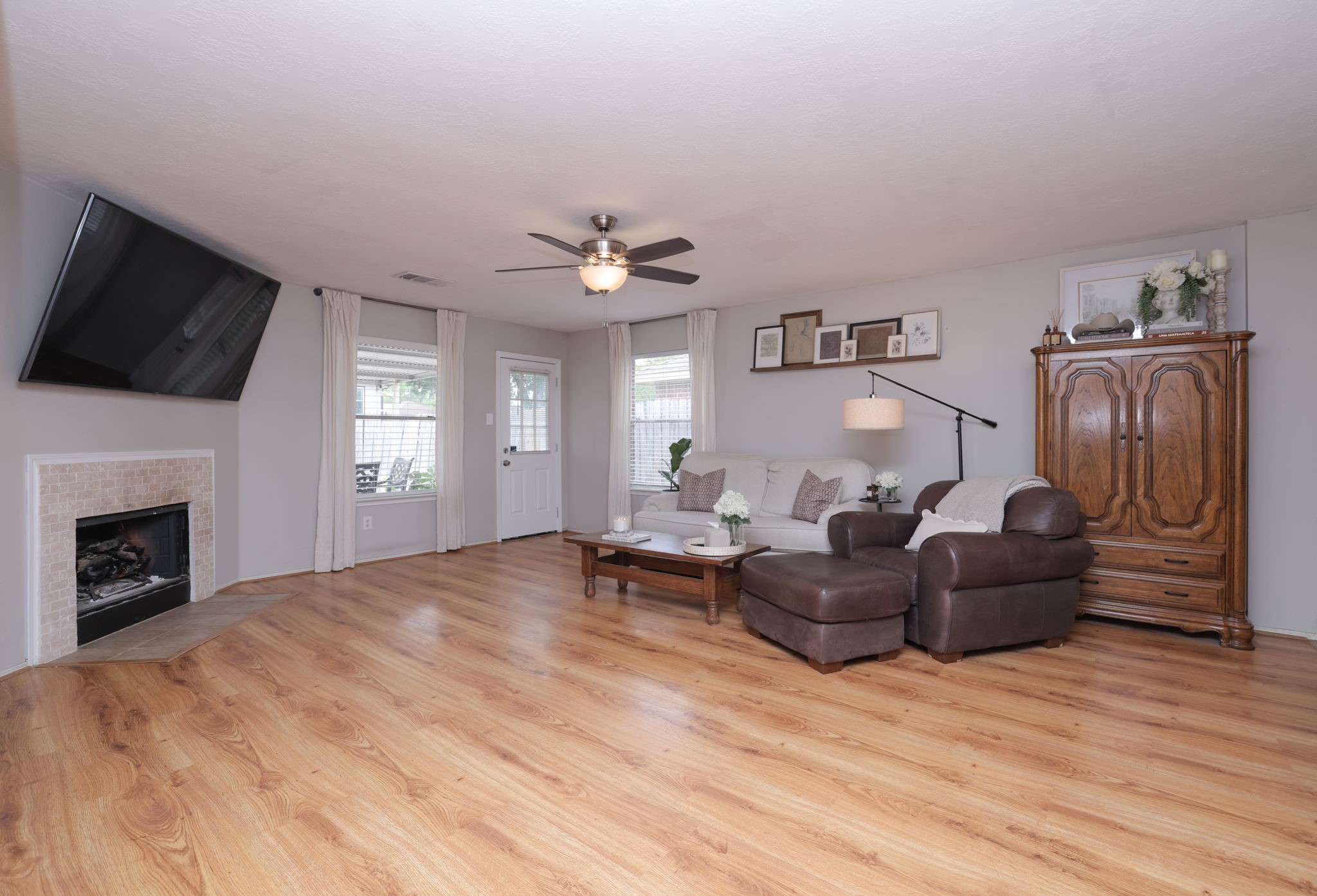 3803 Oaklace Drive Spring, TX 77389 - Photo 18 of 36 a living room with furniture a fireplace and a flat screen tv