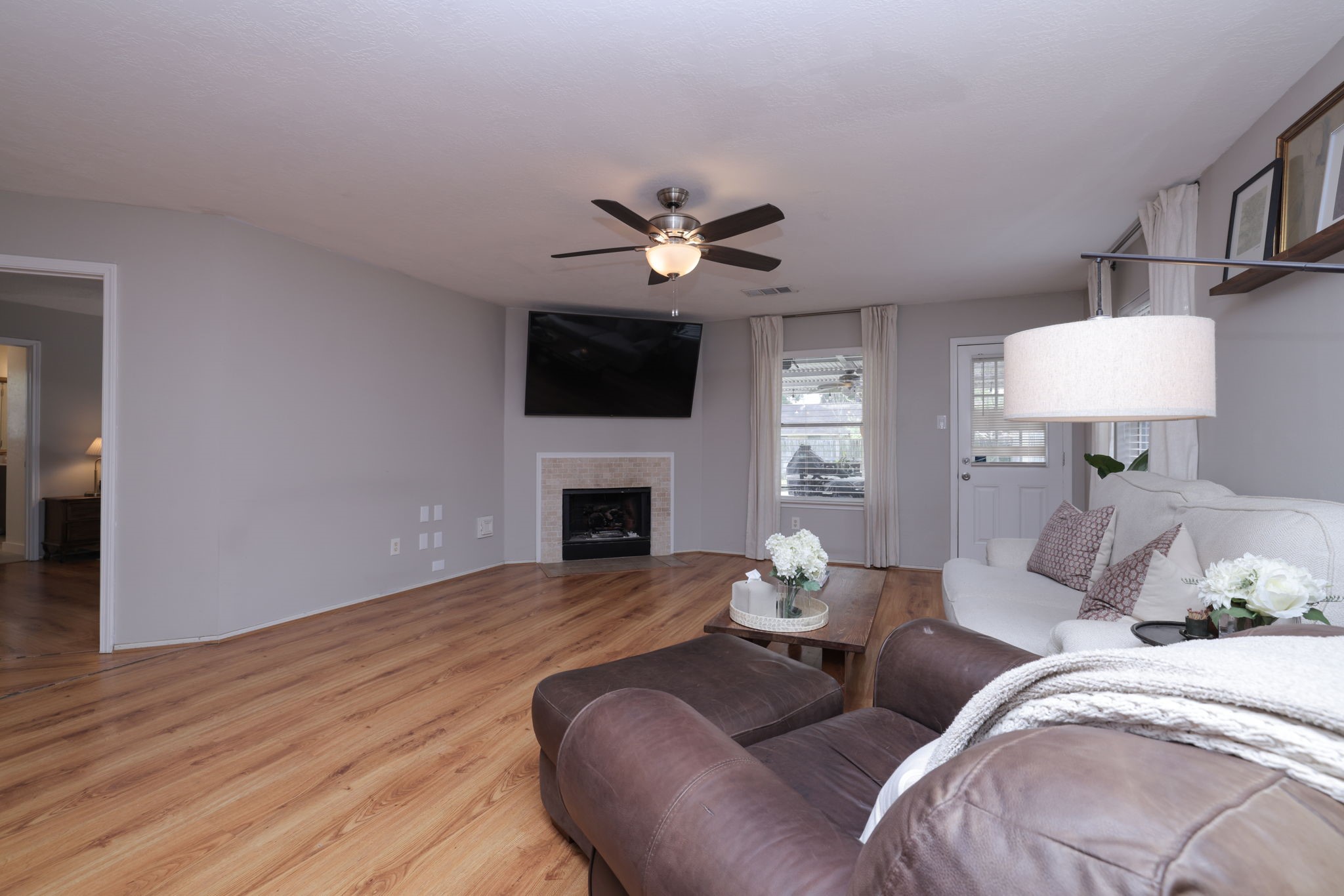 3803 Oaklace Drive Spring, TX 77389 - Photo 21 of 36 a living room with furniture a fireplace and a flat screen tv