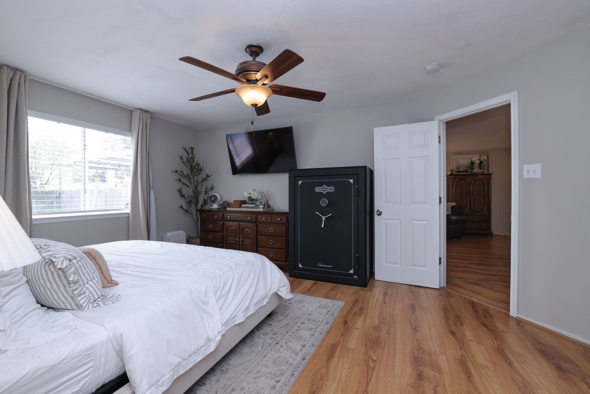 3803 Oaklace Drive Spring, TX 77389 - Photo 23 of 36 a bedroom with a bed and a chandelier