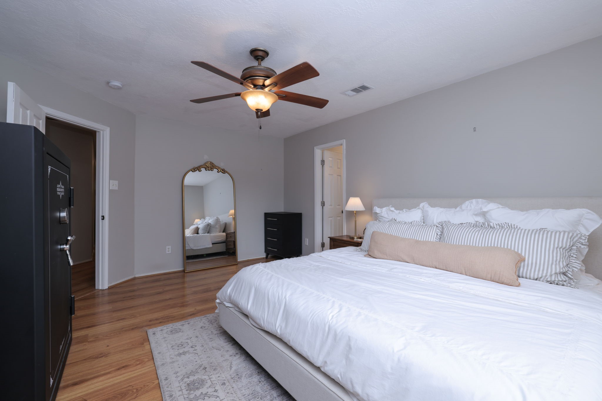 3803 Oaklace Drive Spring, TX 77389 - Photo 24 of 36 a spacious bedroom with a bed and a chandelier