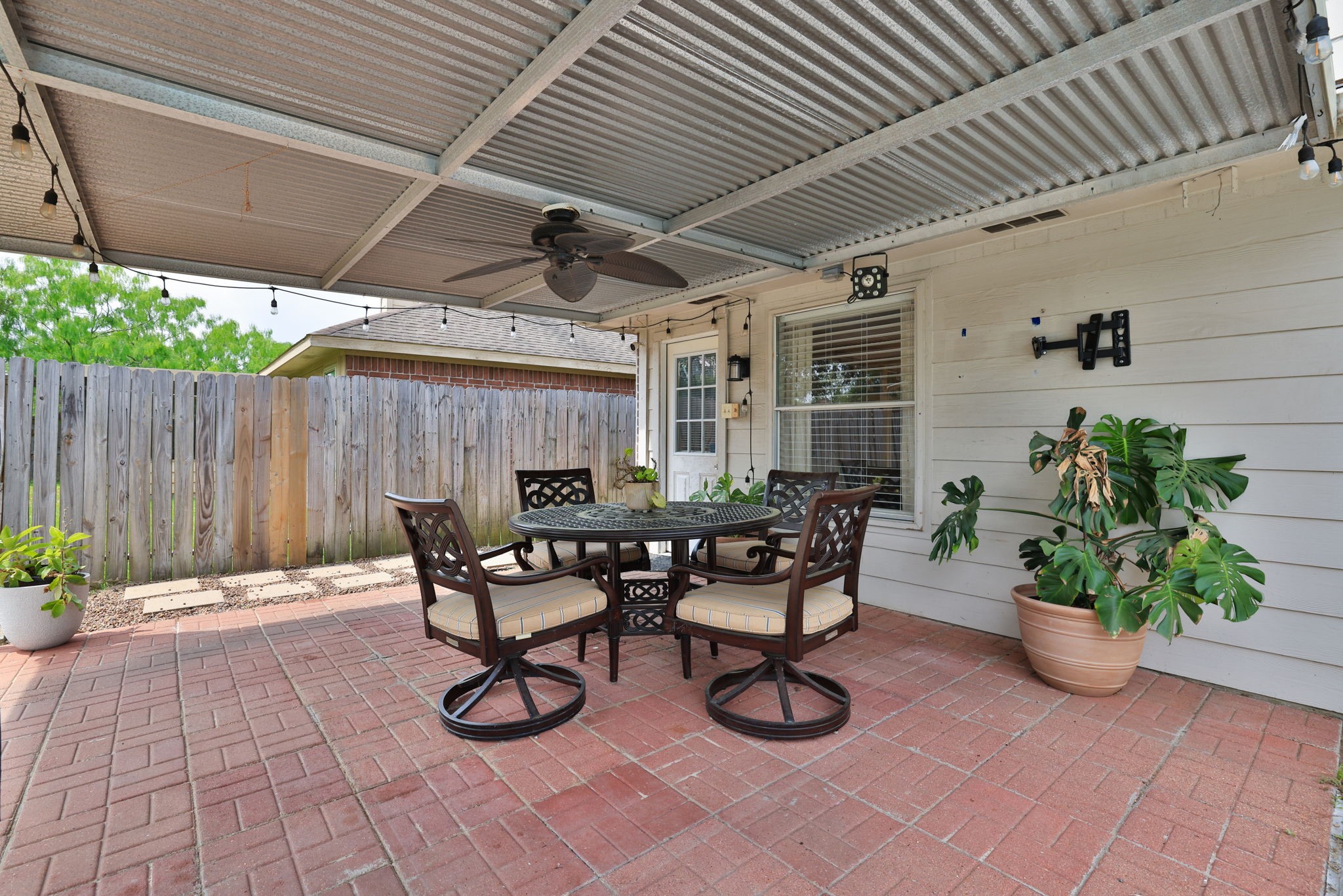 3803 Oaklace Drive Spring, TX 77389 - Photo 28 of 36 a view of a patio with table and chairs potted plants with wooden fence