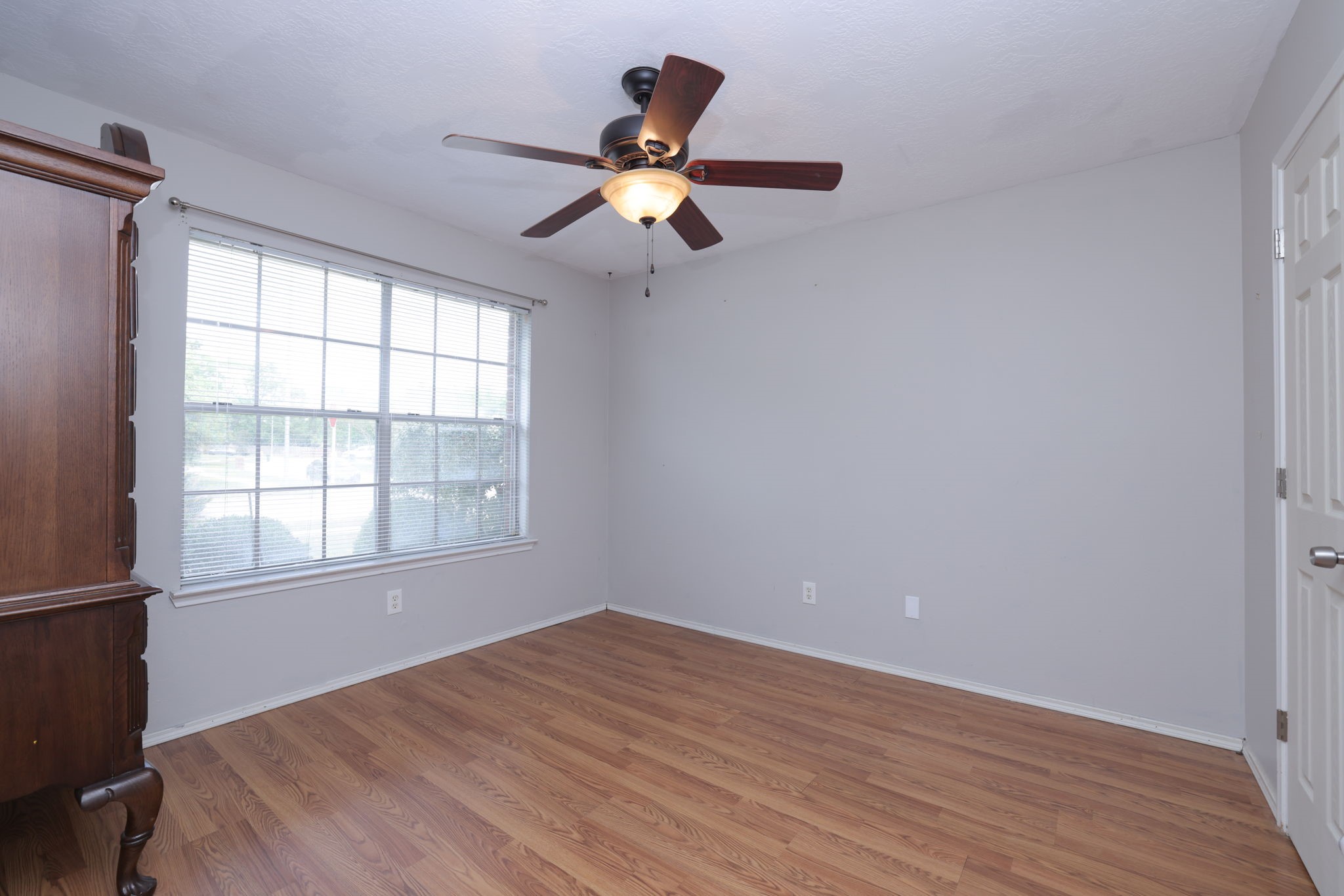 3803 Oaklace Drive Spring, TX 77389 - Photo 7 of 36 an empty room with wooden floor fan and windows