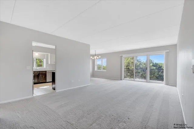 an empty room with windows and entrance