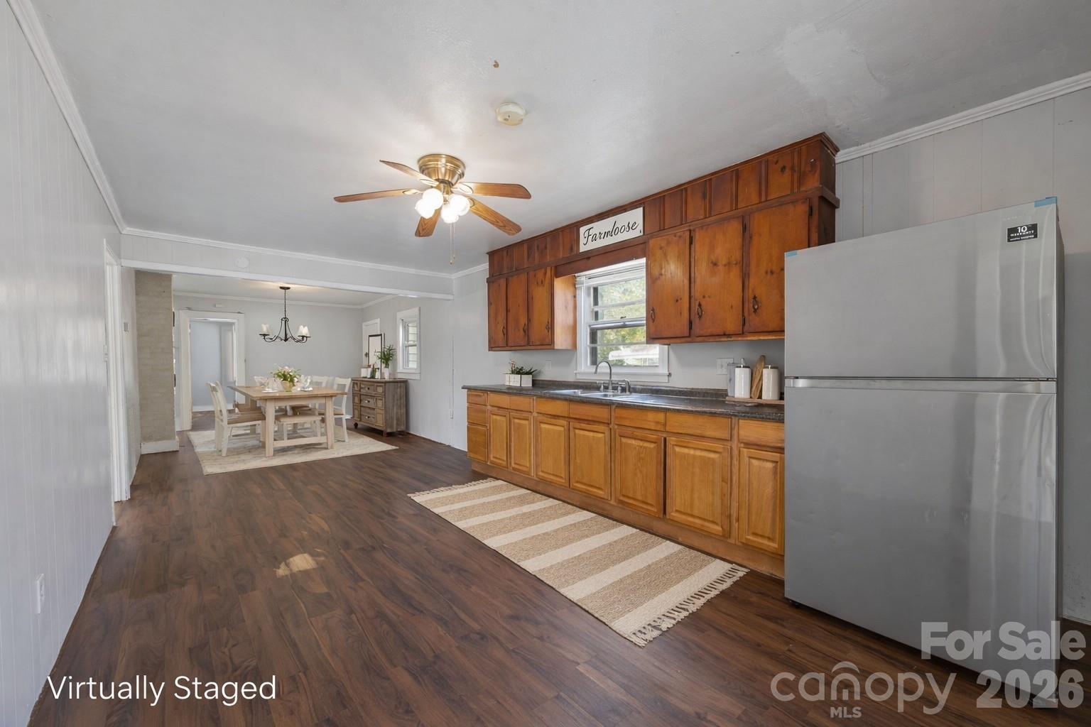208 Ellis Street Albemarle, NC 28001 - Photo 11 of 38 a kitchen with a refrigerator and a stove top oven