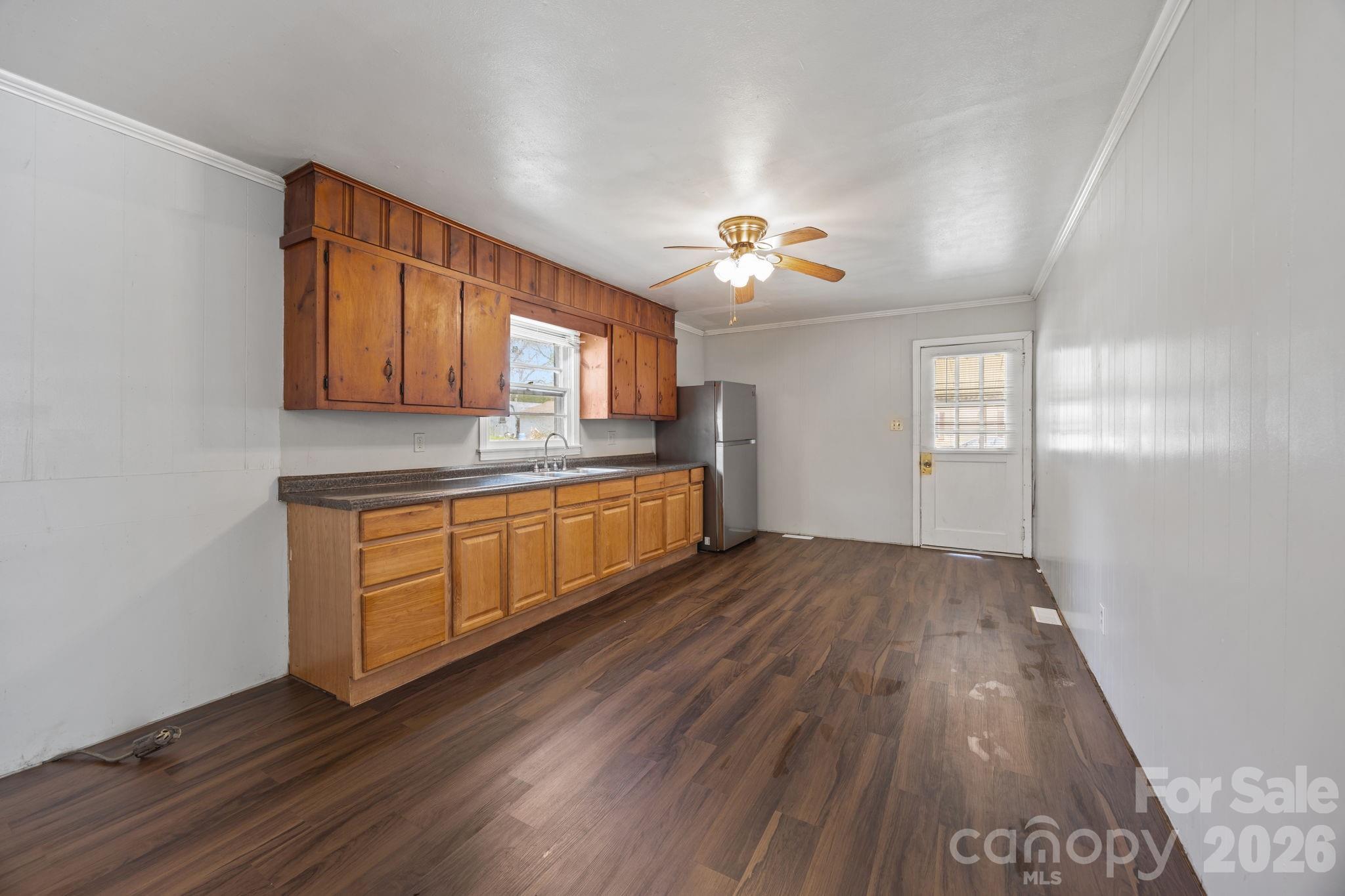 208 Ellis Street Albemarle, NC 28001 - Photo 12 of 38 a kitchen with cabinets a sink and appliances