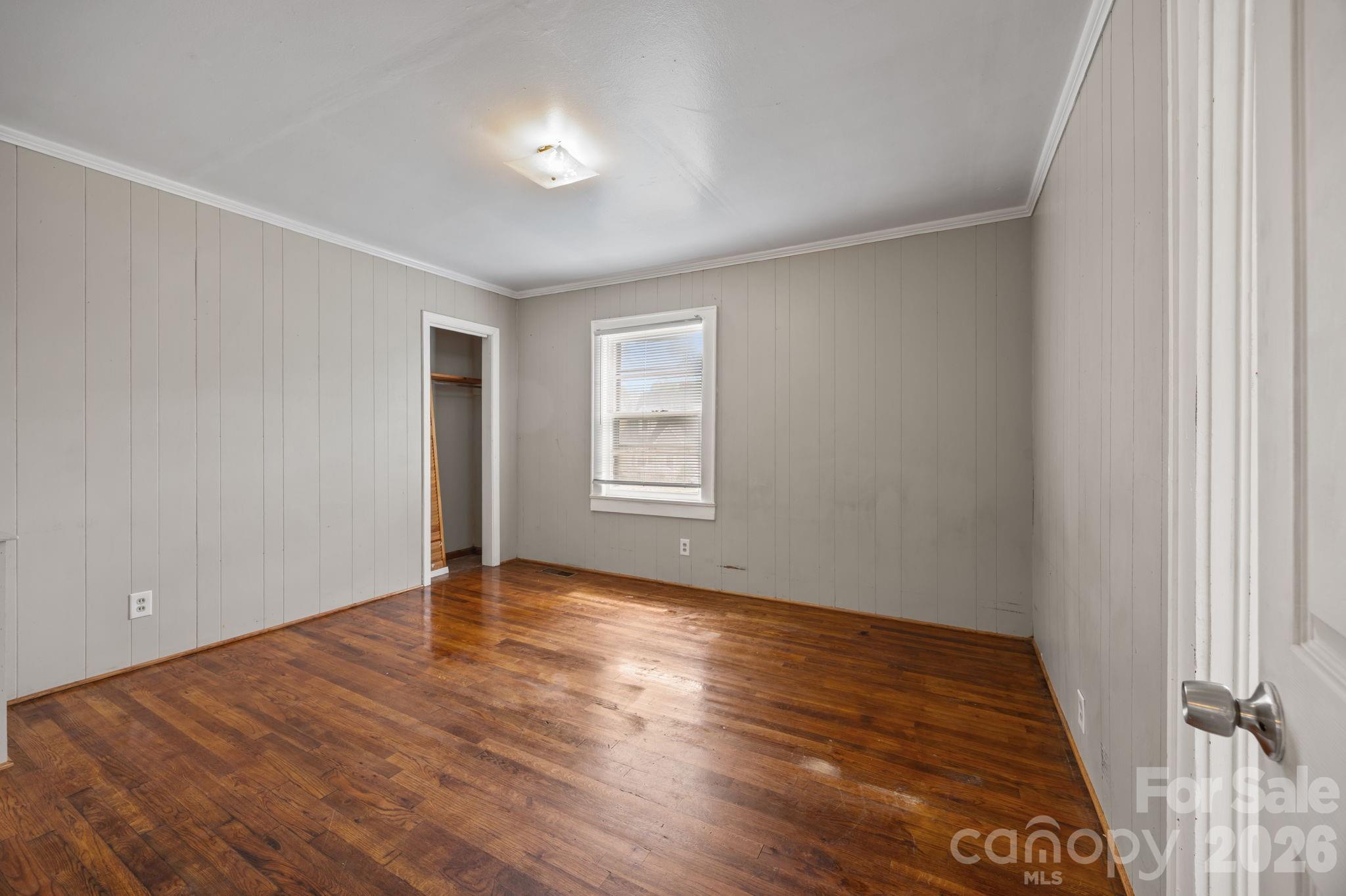 208 Ellis Street Albemarle, NC 28001 - Photo 15 of 38 a view of an empty room with wooden floor and a window
