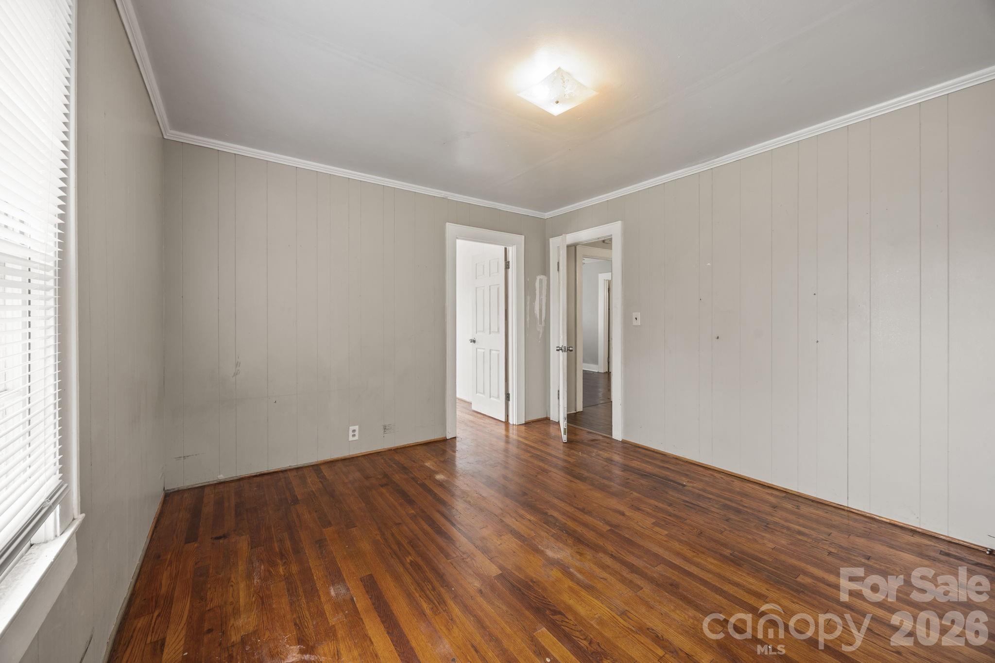 208 Ellis Street Albemarle, NC 28001 - Photo 16 of 38 an empty room with wooden floor and windows