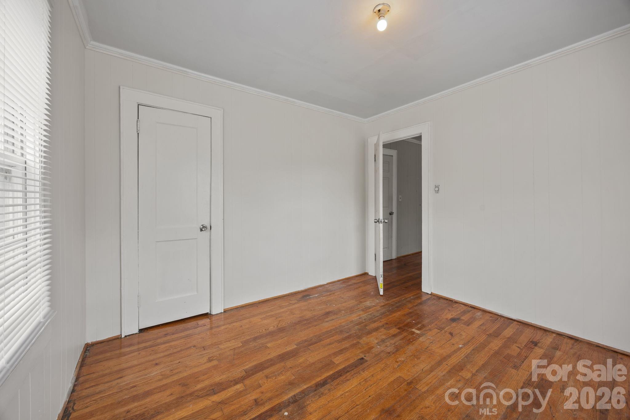208 Ellis Street Albemarle, NC 28001 - Photo 20 of 38 a view of an empty room with wooden floor and closet