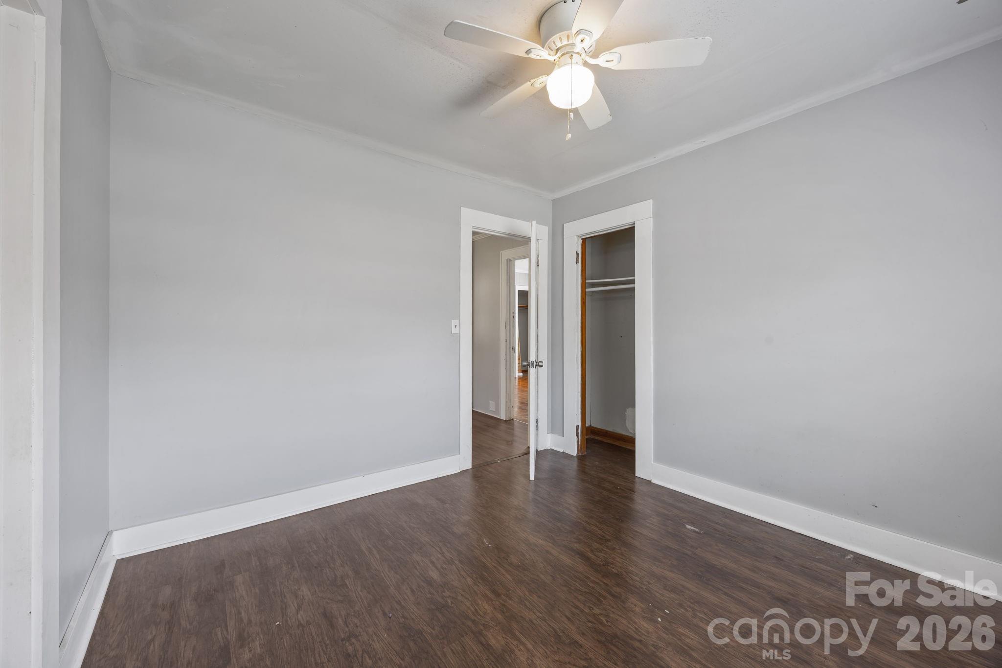 208 Ellis Street Albemarle, NC 28001 - Photo 23 of 38 an empty room with wooden floor and fan