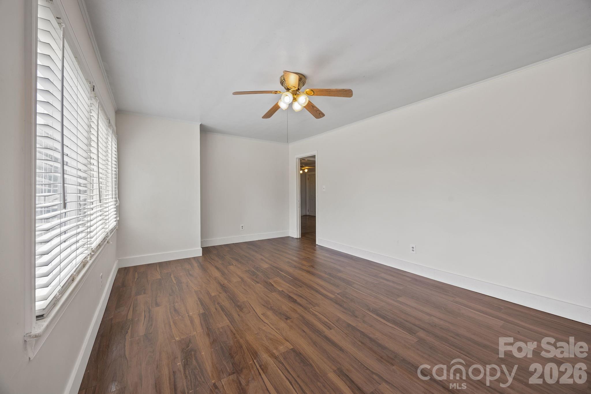 208 Ellis Street Albemarle, NC 28001 - Photo 5 of 38 a view of empty room with wooden floor and fan